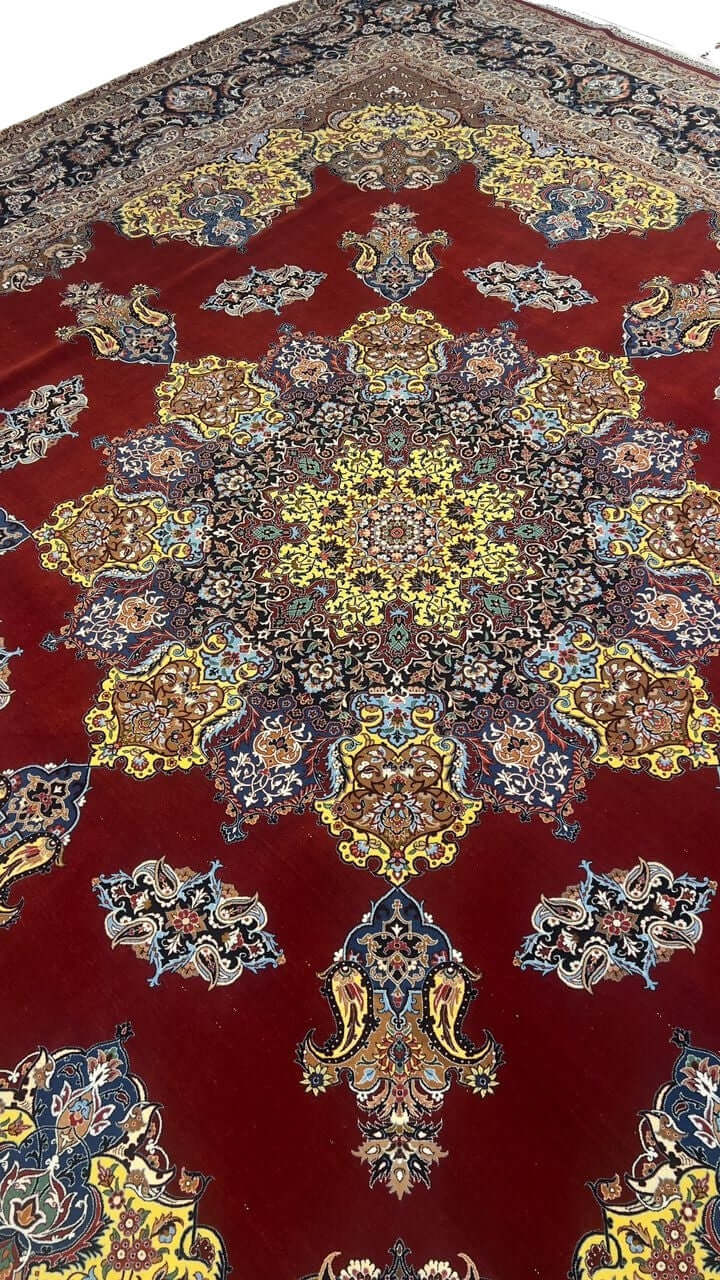 "Luxurious Persian rug showcasing intricate floral and paisley motifs in bold red, yellow, and blue hues."